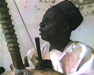 Amadu Bansang Jobarteh playing the <em>kora</em> at his home in The Gambia, 1989. Image from video © Eric Charry.
