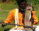 Nur Muhammad, an itinerant musician (<em>jogi</em>), plays the <em>sārangī</em> while singing <em>daha</em>s. Hallaur, Basti district, Uttar Pradesh, 1998. Image from video © Richard Wolf.