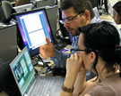 EVIA Project Director Alan Burdette explains the <em>Annotator's Workbench</em> software to Summer Institute participant Andrea Emberly. Bloomington, Indiana, 2008. Image © Clara Henderson.