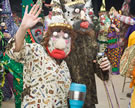 Two masked Mermentau Mardi Gras dance during a house stop in Mermentau Cove, Louisiana, 2007. Image © John Laudun.