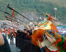Trumpeters and lion dancers commemorate the opening of a culture and ecology park near the city of Leye, western Guangxi Zhuang Autonomous Region, China, 2003. Image © Jessica Anderson Turner.