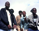 Members of the Ghost Face Clan, a sub-group of the C.O.B. Connection, rehearse a cappella in the hills above Blantyre, 2000. From left to right: Mutinji, Mad Muffin, Red Gun, and Meckai B. Image © John Fenn.